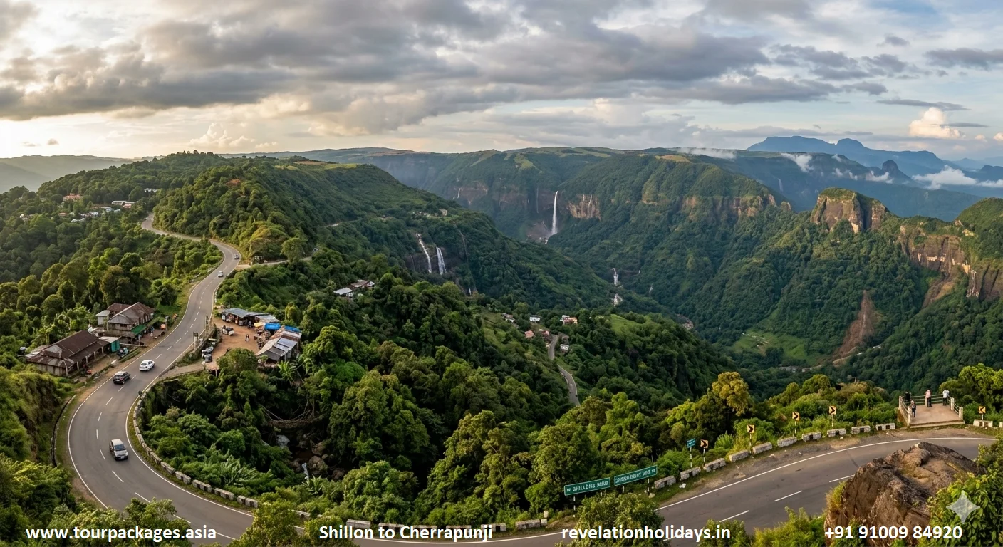 Shillong to Cherrapunji road in Meghalaya — aerial panorama of a deep limestone gorge with a massive waterfall (Nohkalikai) cascading down the escarpment, lush green forested khasi hills, hairpin bends on the road visible in foreground and dramatic cloud formation overhead